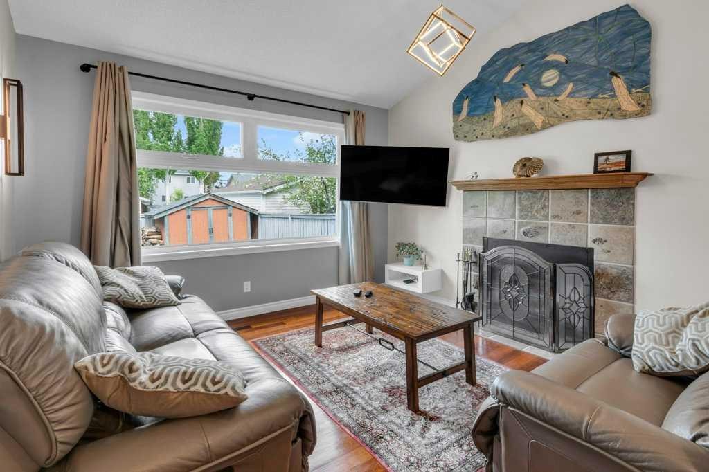 42 River Rock Green Se, Calgary, AB - Indoor Photo Showing Living Room With Fireplace