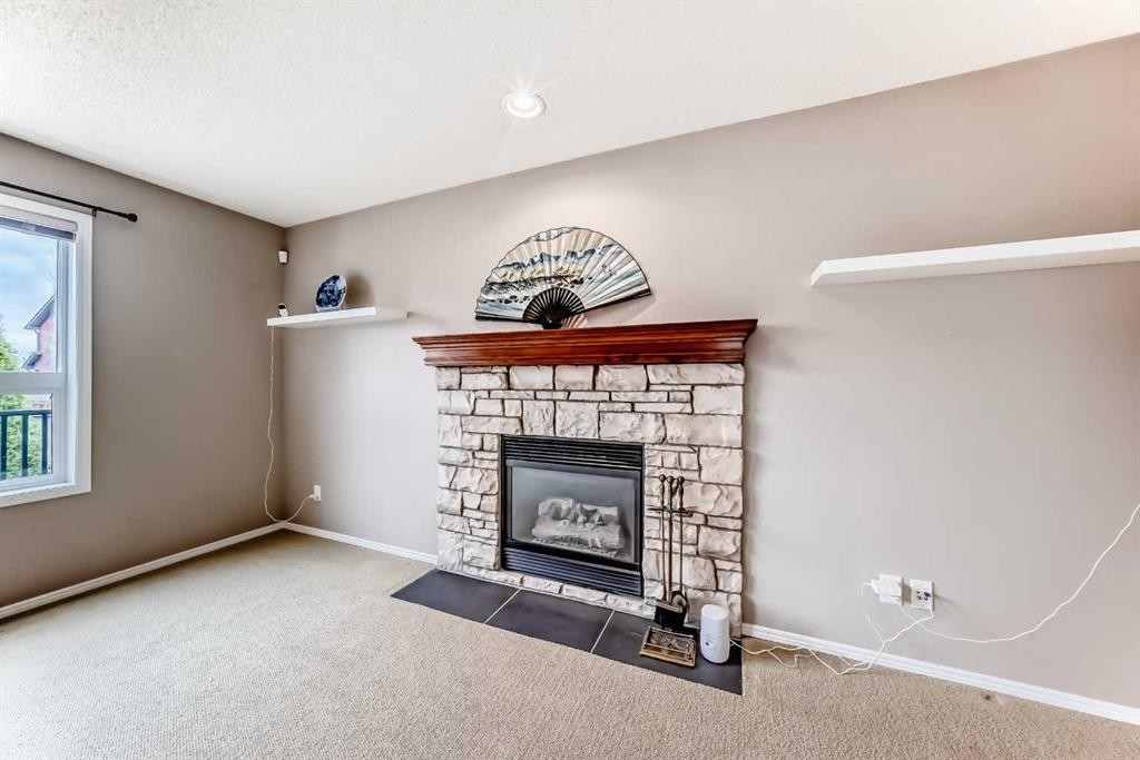 80 Eversyde Way Sw, Calgary, AB - Indoor With Fireplace