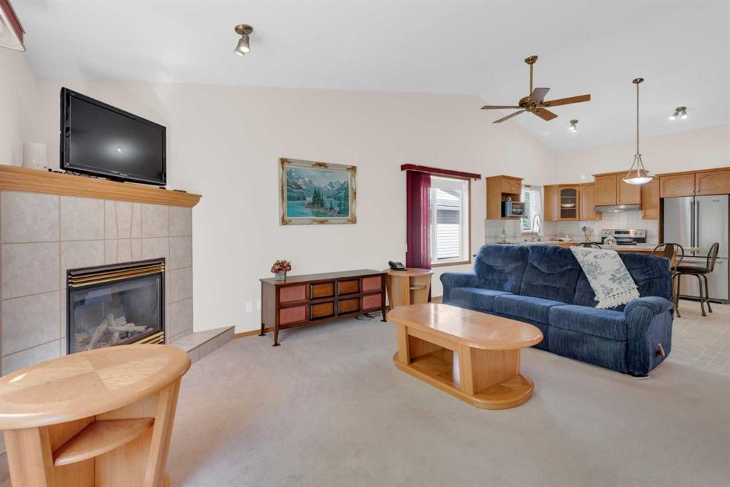 104 Whispering Way, Vulcan, AB - Indoor Photo Showing Living Room With Fireplace