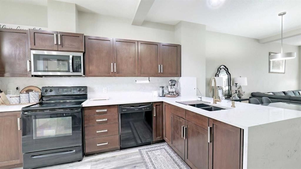 54 New Brighton Point Se, Calgary, AB - Indoor Photo Showing Kitchen With Double Sink