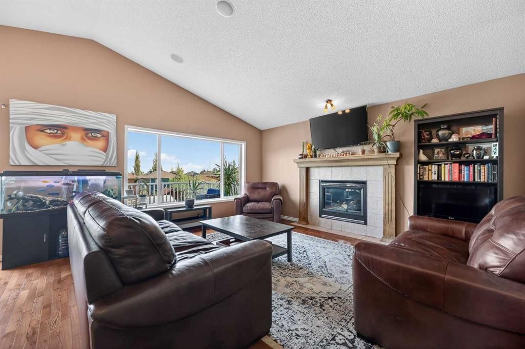 44 Bridlepost Green Sw, Calgary, AB - Indoor Photo Showing Living Room With Fireplace