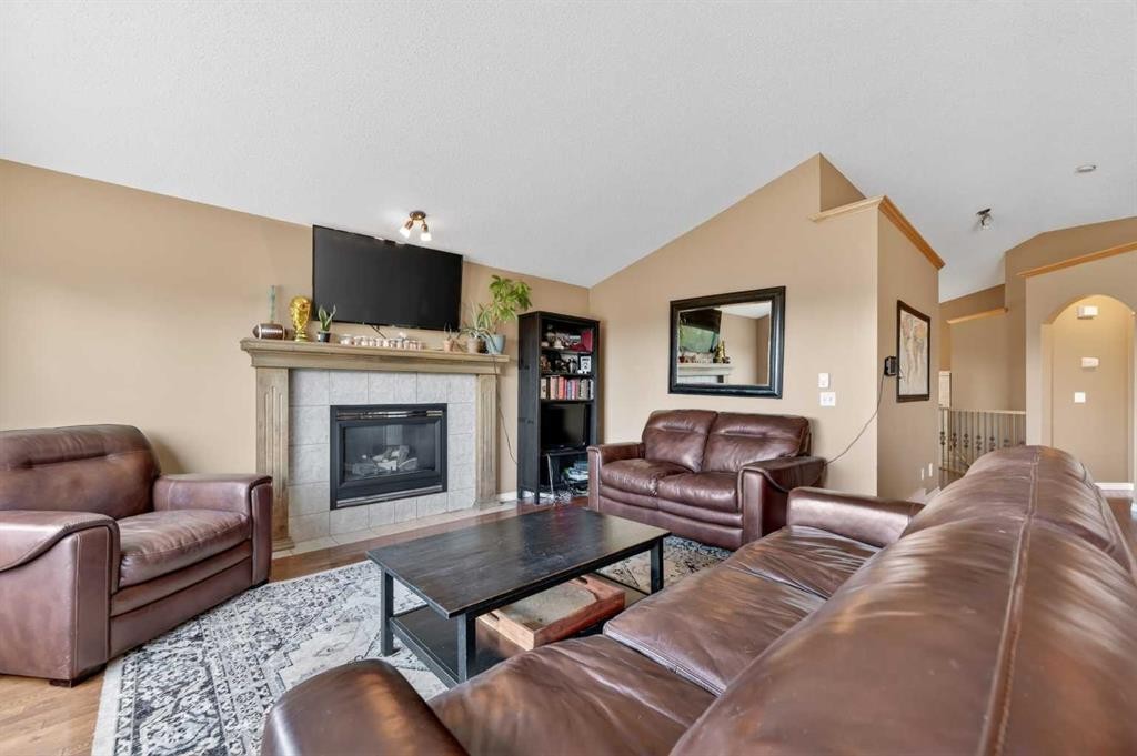 44 Bridlepost Green Sw, Calgary, AB - Indoor Photo Showing Living Room With Fireplace