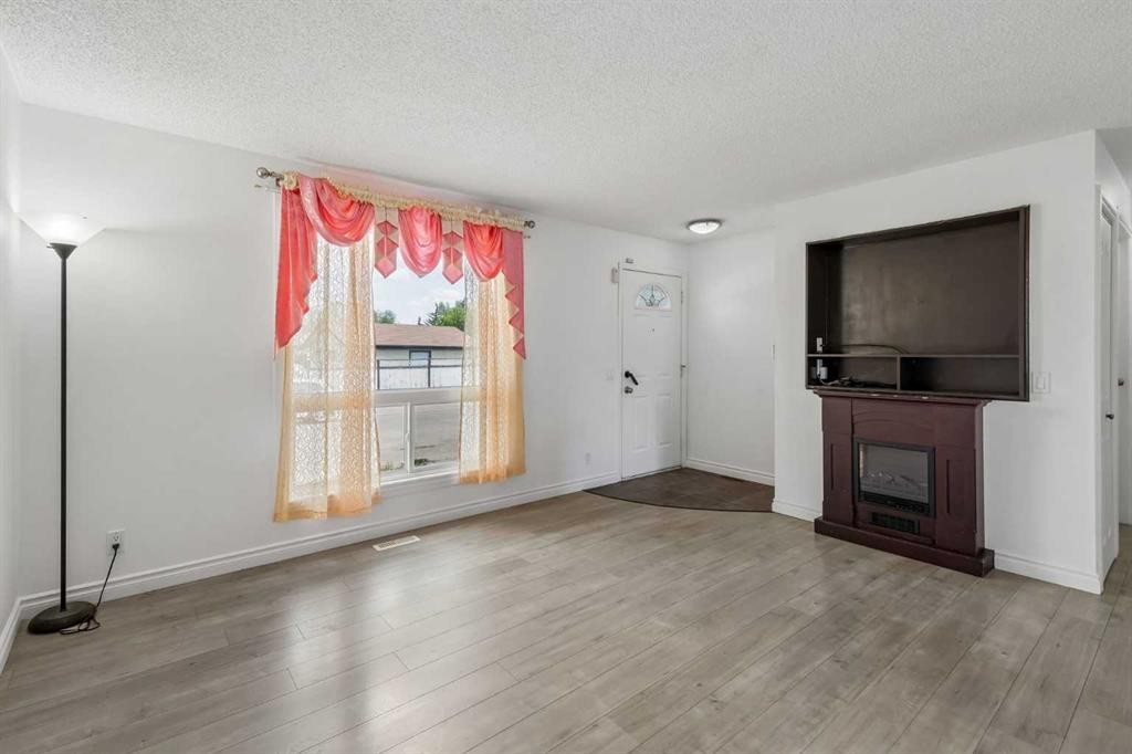 83 Appletree Close Se, Calgary, AB - Indoor Photo Showing Living Room With Fireplace