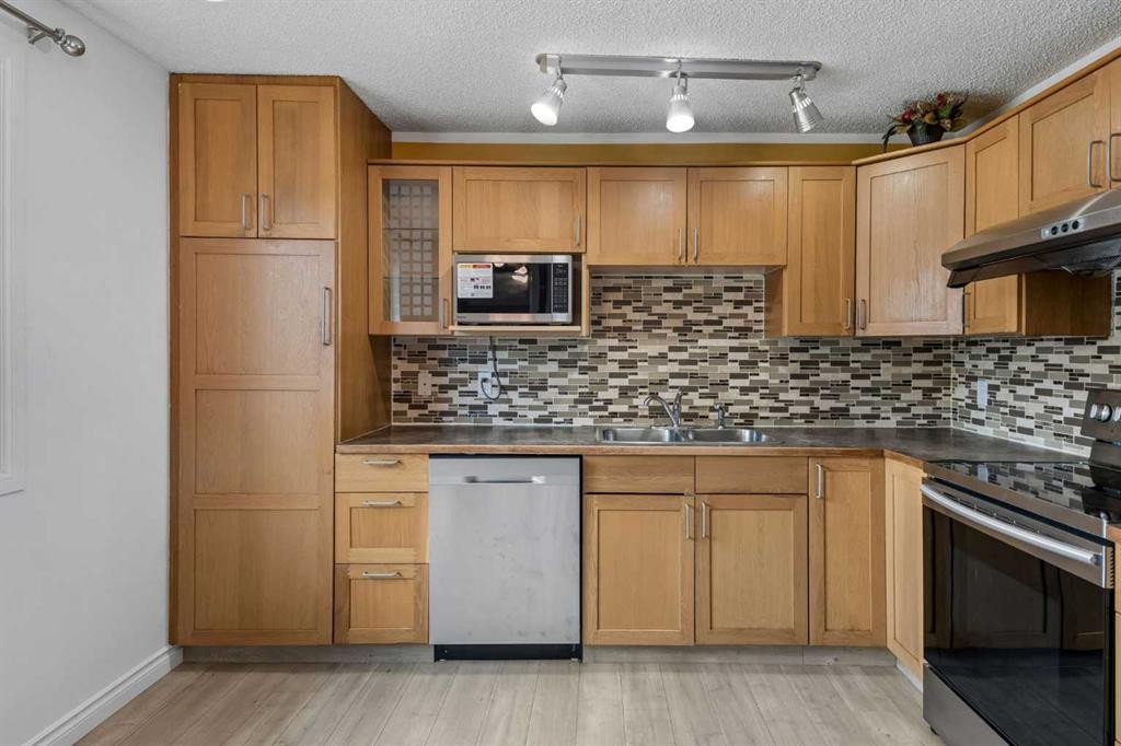 83 Appletree Close Se, Calgary, AB - Indoor Photo Showing Kitchen With Double Sink