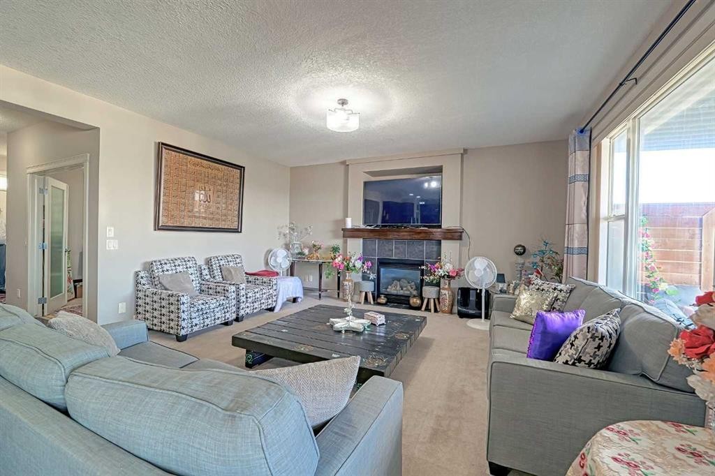 247 Pantego Way Nw, Calgary, AB - Indoor Photo Showing Living Room With Fireplace