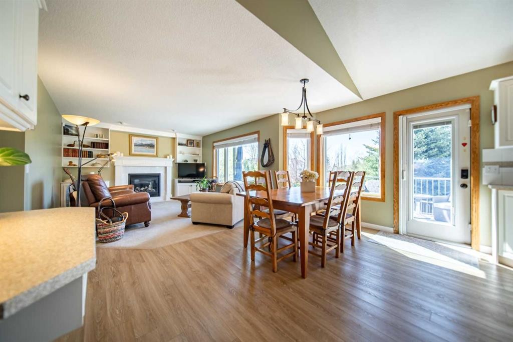 76 Sunset Crescent, Okotoks, AB - Indoor Photo Showing Dining Room With Fireplace