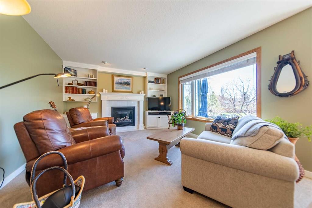 76 Sunset Crescent, Okotoks, AB - Indoor Photo Showing Living Room With Fireplace