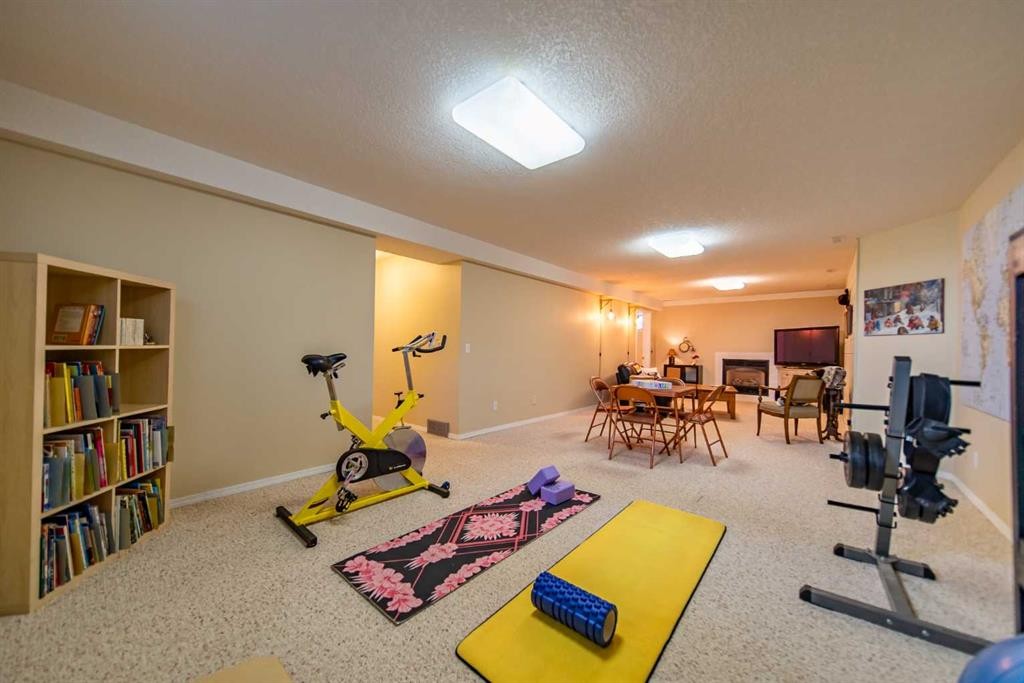 76 Sunset Crescent, Okotoks, AB - Indoor Photo Showing Gym Room