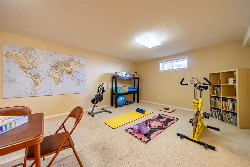 76 Sunset Crescent, Okotoks, AB - Indoor Photo Showing Gym Room