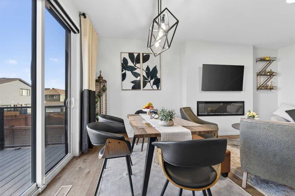 36 Royston Rise Nw, Calgary, AB - Indoor Photo Showing Dining Room With Fireplace