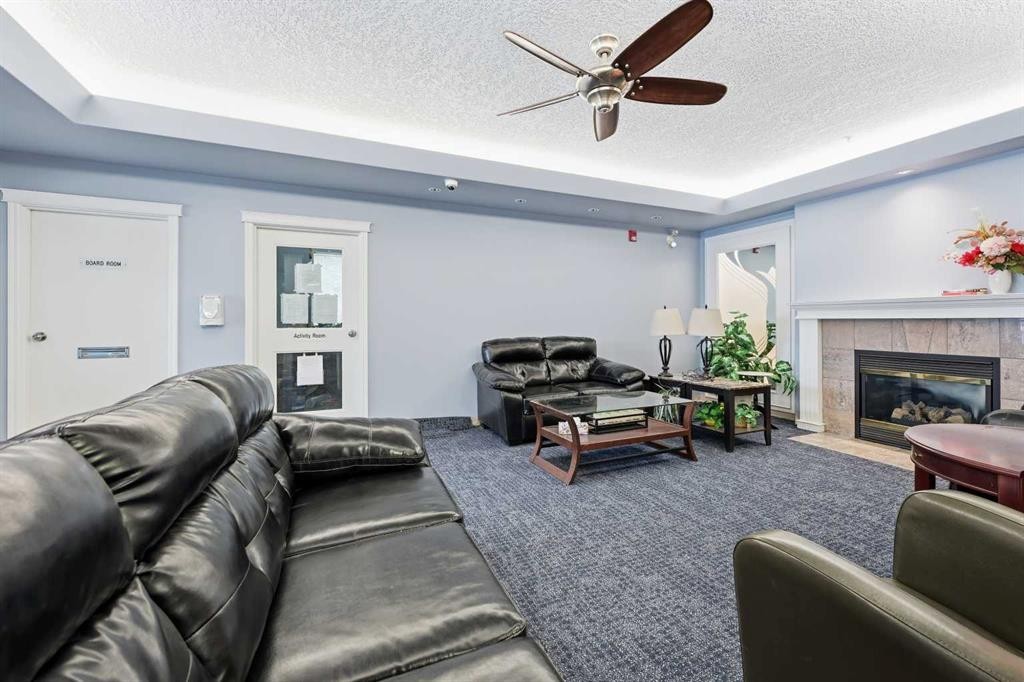 439-165 Manora Place Ne, Calgary, AB - Indoor Photo Showing Living Room With Fireplace