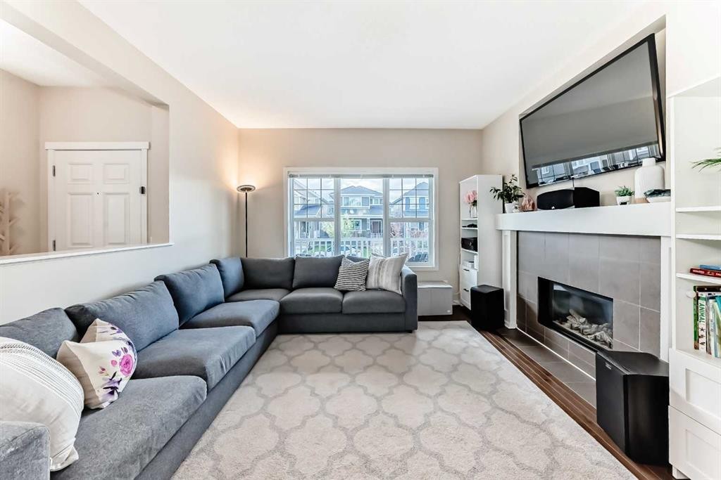 199 River Heights Green, Cochrane, AB - Indoor Photo Showing Living Room With Fireplace