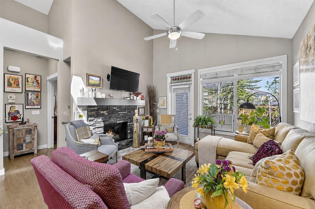 43 Cortina Villas Sw, Calgary, AB - Indoor Photo Showing Living Room With Fireplace