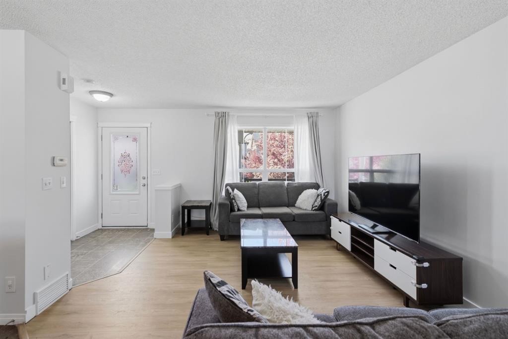 80 Prestwick Bay Se, Calgary, AB - Indoor Photo Showing Living Room