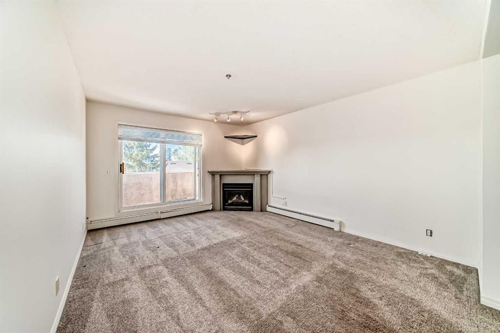 317-649 Marsh Road Ne, Calgary, AB - Indoor Photo Showing Living Room With Fireplace