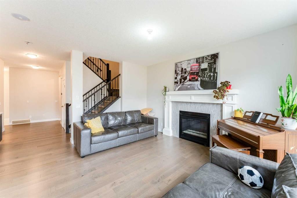 42 Buckskin Way, Cochrane, AB - Indoor Photo Showing Living Room With Fireplace