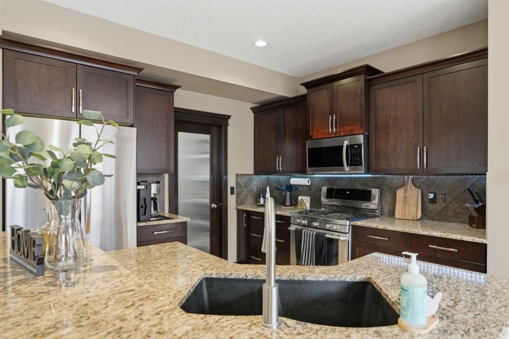 44 Westridge Crescent, Okotoks, AB - Indoor Photo Showing Kitchen With Stainless Steel Kitchen With Double Sink With Upgraded Kitchen