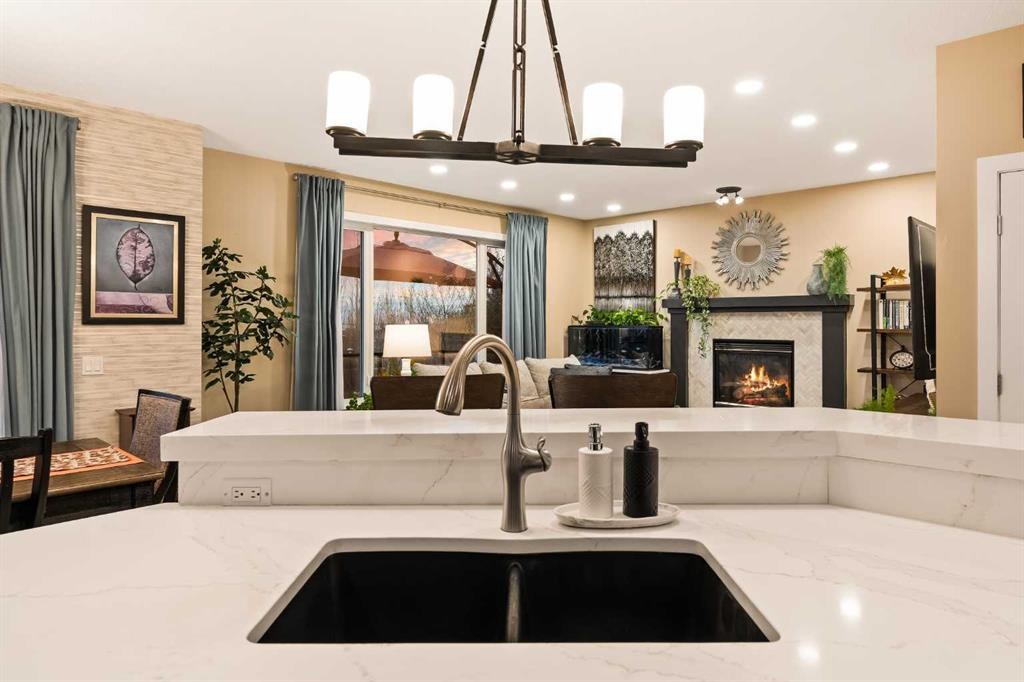 62 Panamount View Nw, Calgary, AB - Indoor Photo Showing Kitchen With Fireplace With Double Sink