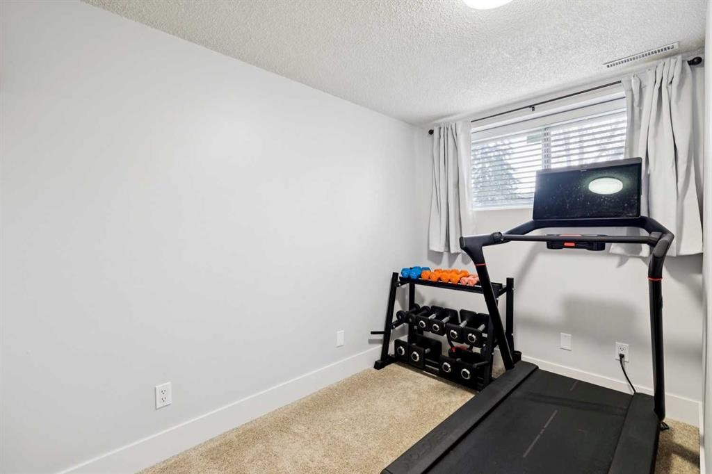 162 Fyffe Road Se, Calgary, AB - Indoor Photo Showing Gym Room