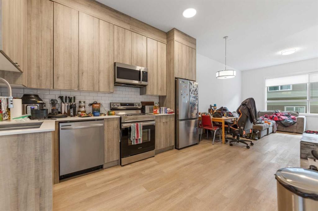 211-101 Panatella Square Nw, Calgary, AB - Indoor Photo Showing Kitchen With Double Sink