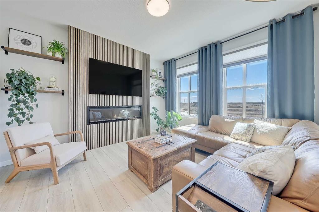 164 Setonstone Manor Se, Calgary, AB - Indoor Photo Showing Living Room With Fireplace