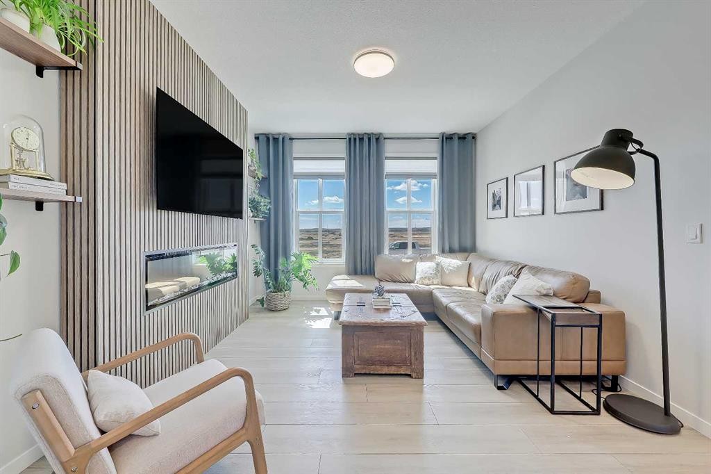 164 Setonstone Manor Se, Calgary, AB - Indoor Photo Showing Living Room With Fireplace