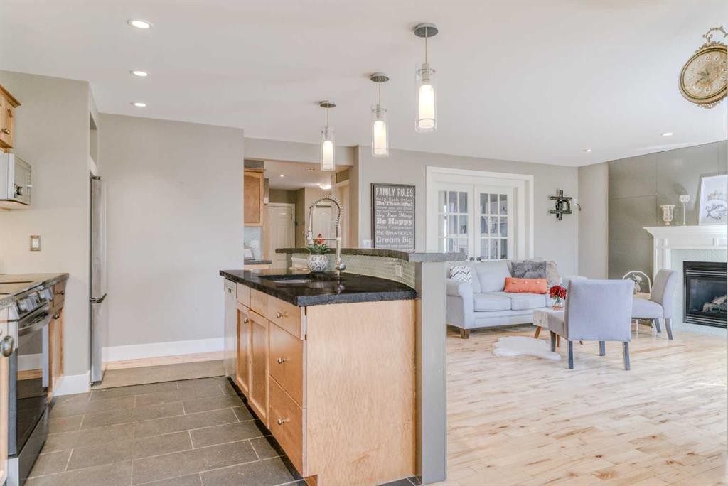 100 Royal Birch Crescent Nw, Calgary, AB - Indoor Photo Showing Kitchen With Fireplace With Upgraded Kitchen