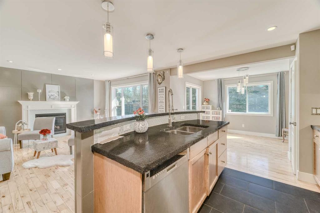 100 Royal Birch Crescent Nw, Calgary, AB - Indoor Photo Showing Kitchen With Fireplace With Double Sink