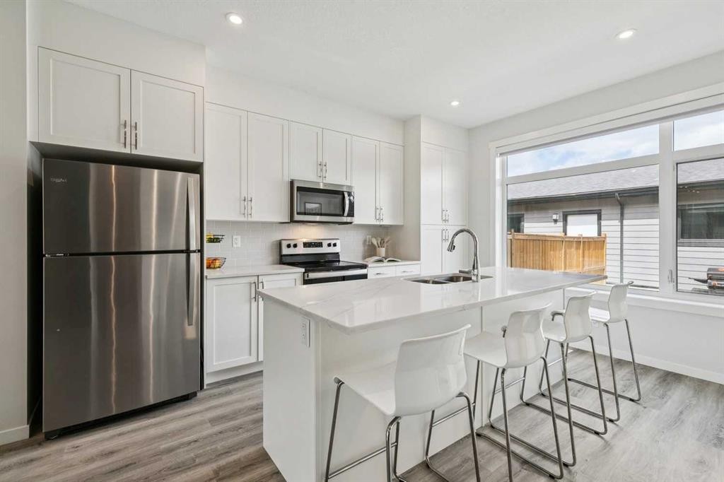 201 Vantage Drive, Cochrane, AB - Indoor Photo Showing Kitchen With Stainless Steel Kitchen With Double Sink With Upgraded Kitchen