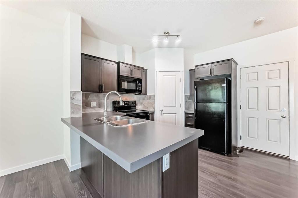 76 Copperpond Landing Se, Calgary, AB - Indoor Photo Showing Kitchen With Double Sink