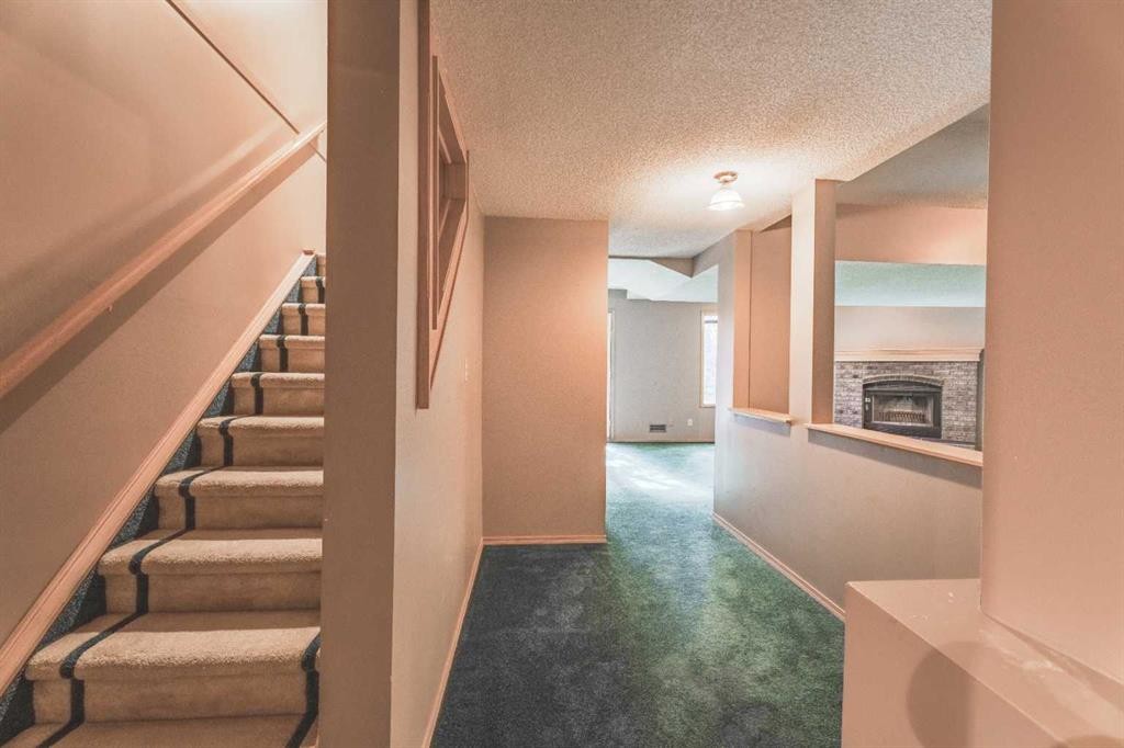 135 Canterbury Court Sw, Calgary, AB - Indoor Photo Showing Other Room With Fireplace