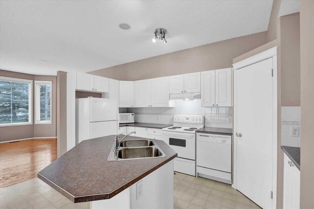 231 Tuscany Drive Nw, Calgary, AB - Indoor Photo Showing Kitchen With Double Sink