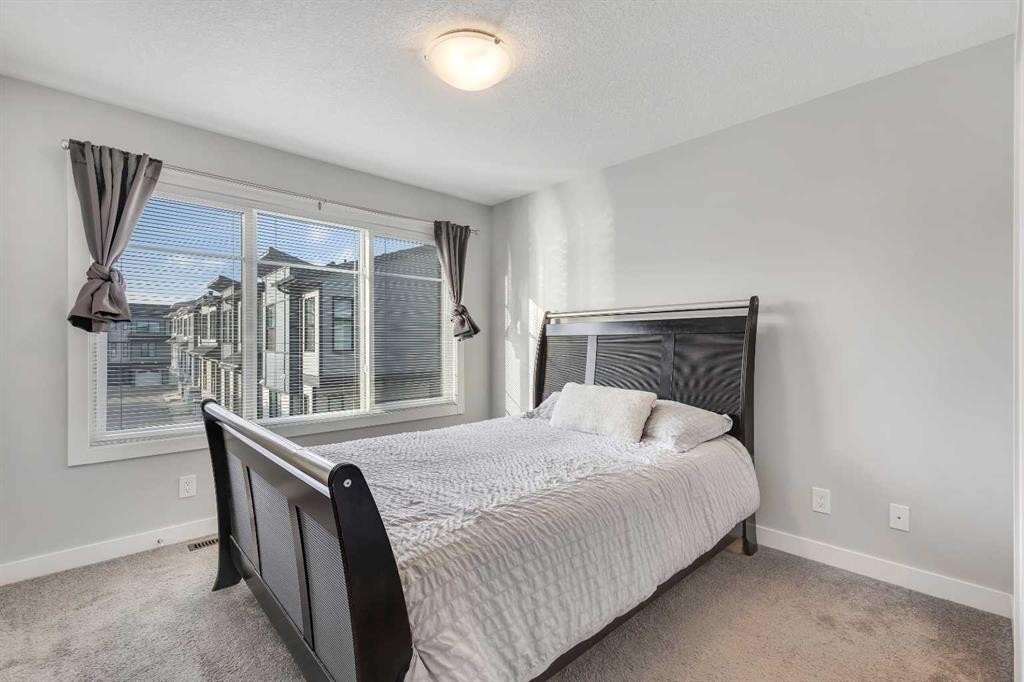 154 Seton Passage Se, Calgary, AB - Indoor Photo Showing Bedroom