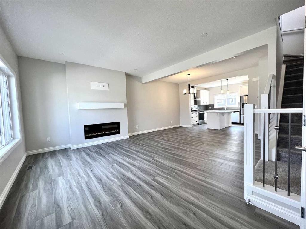 30 Emberside Link, Cochrane, AB - Indoor Photo Showing Living Room With Fireplace