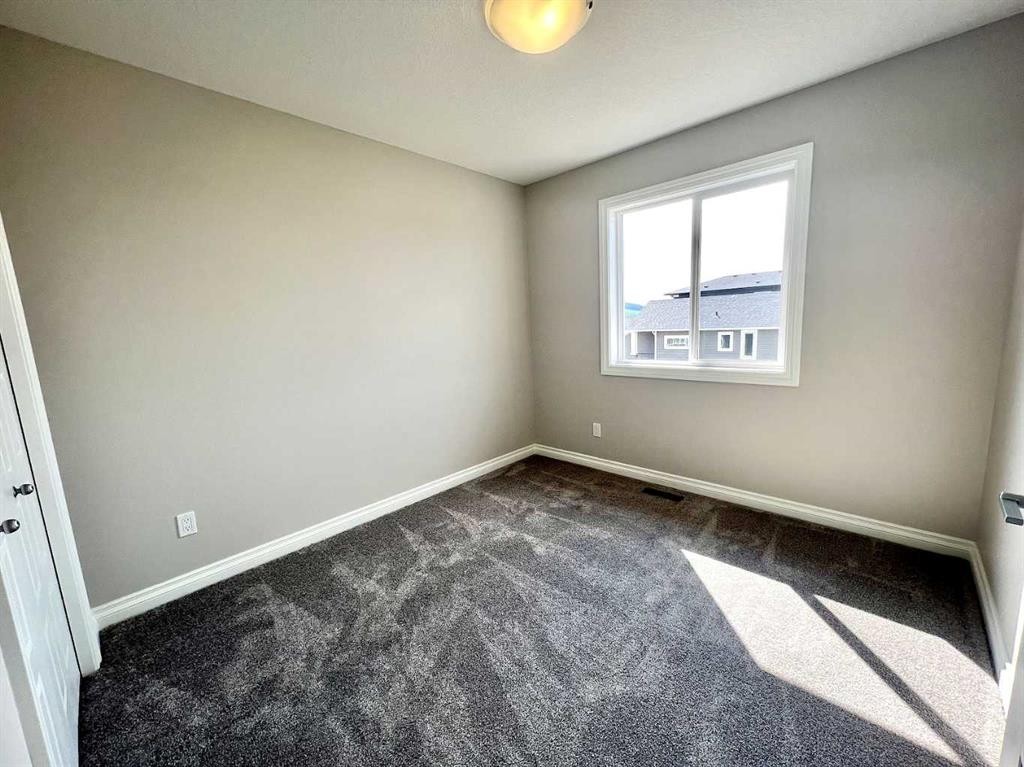 30 Emberside Link, Cochrane, AB - Indoor Photo Showing Other Room