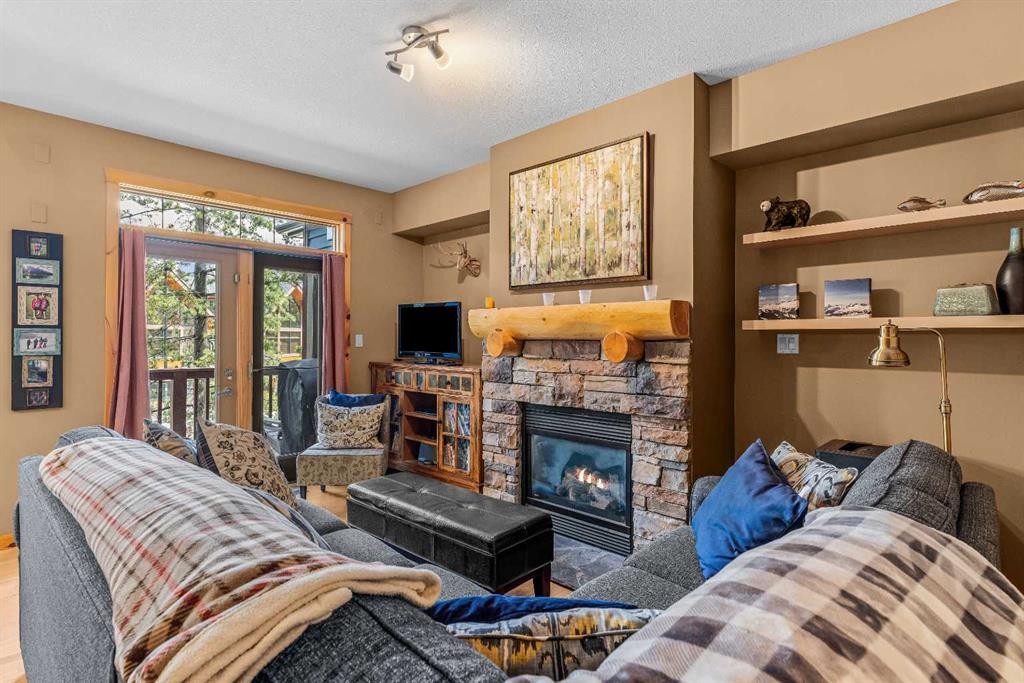 1003-70 Dyrgas Gate, Canmore, AB - Indoor Photo Showing Other Room With Fireplace