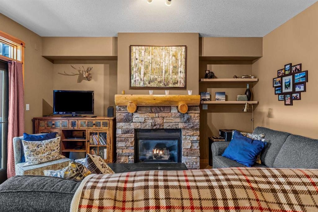 1003-70 Dyrgas Gate, Canmore, AB - Indoor Photo Showing Other Room With Fireplace