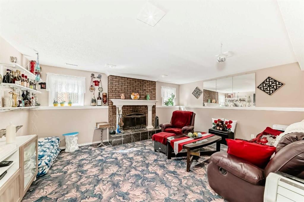 43 Beaconsfield Way Nw, Calgary, AB - Indoor Photo Showing Living Room With Fireplace
