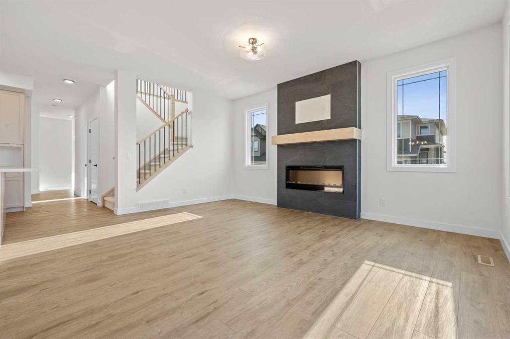 571 Buffaloberry Manor Se, Calgary, AB - Indoor Photo Showing Living Room With Fireplace