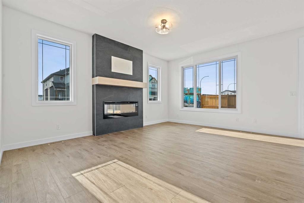 571 Buffaloberry Manor Se, Calgary, AB - Indoor Photo Showing Living Room With Fireplace