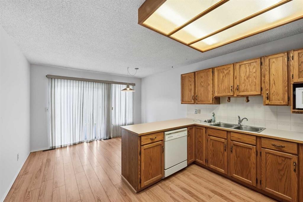 60 Rundlelawn Green Ne, Calgary, AB - Indoor Photo Showing Kitchen With Double Sink