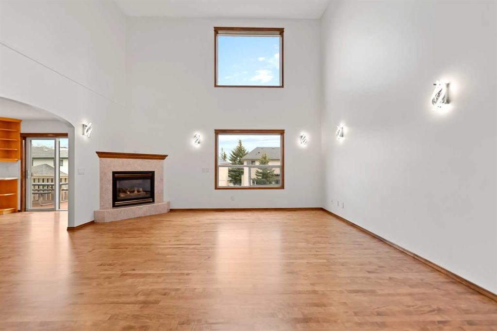410 Long Beach Landing, Chestermere, AB - Indoor Photo Showing Living Room With Fireplace