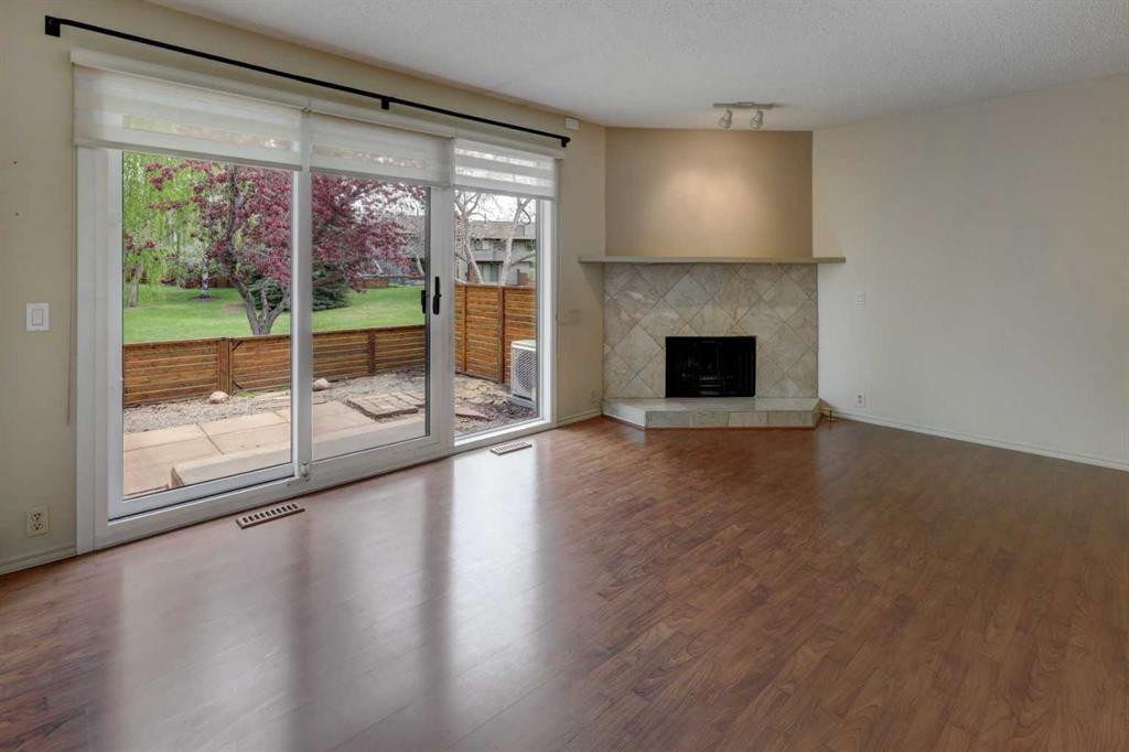 82 Point Drive Nw, Calgary, AB - Indoor Photo Showing Living Room With Fireplace