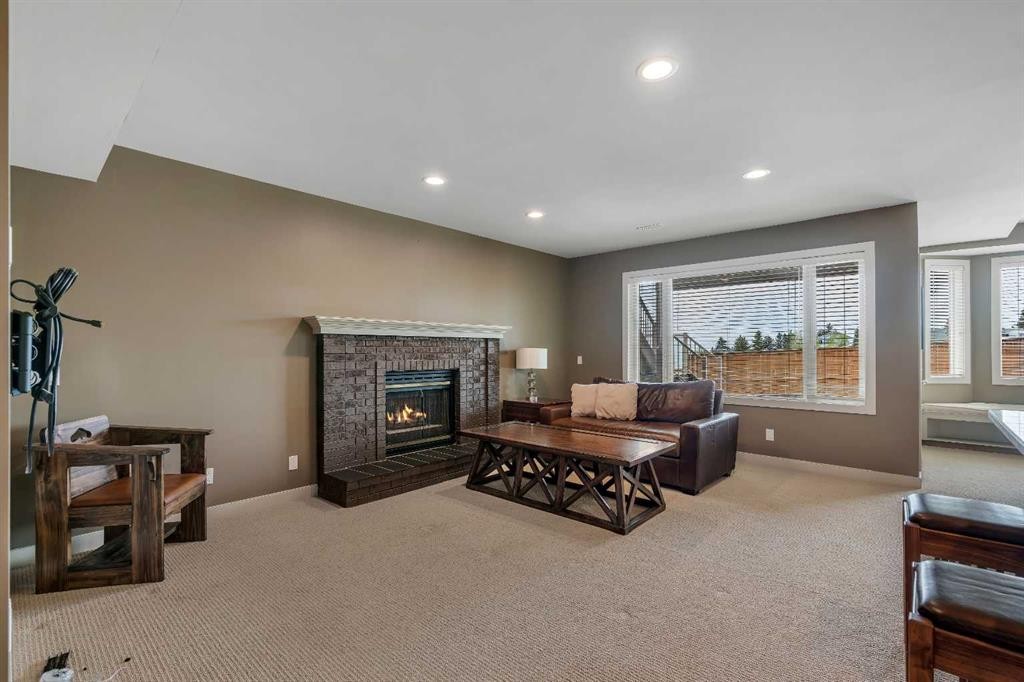 19 Coach Gate Way Sw, Calgary, AB - Indoor Photo Showing Living Room With Fireplace