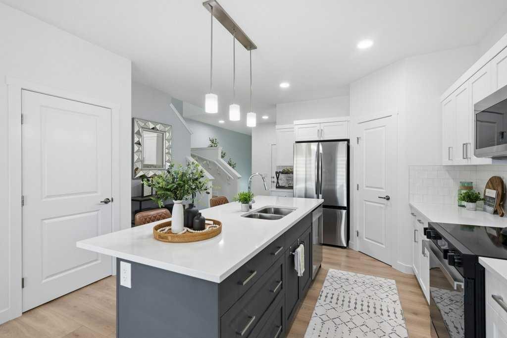 55 Heritage Manor, Cochrane, AB - Indoor Photo Showing Kitchen With Double Sink With Upgraded Kitchen