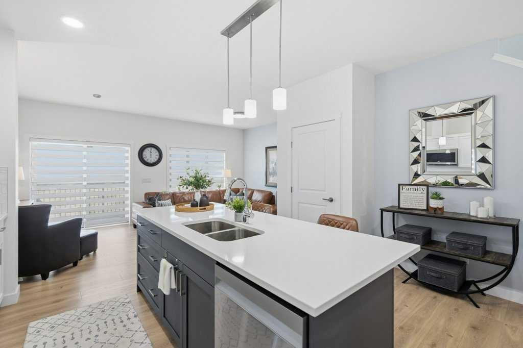55 Heritage Manor, Cochrane, AB - Indoor Photo Showing Kitchen With Double Sink With Upgraded Kitchen