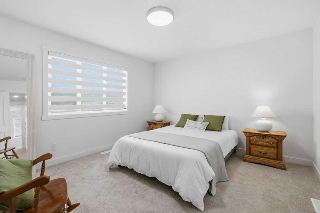 55 Heritage Manor, Cochrane, AB - Indoor Photo Showing Bedroom