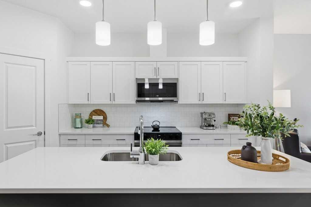 55 Heritage Manor, Cochrane, AB - Indoor Photo Showing Kitchen With Upgraded Kitchen