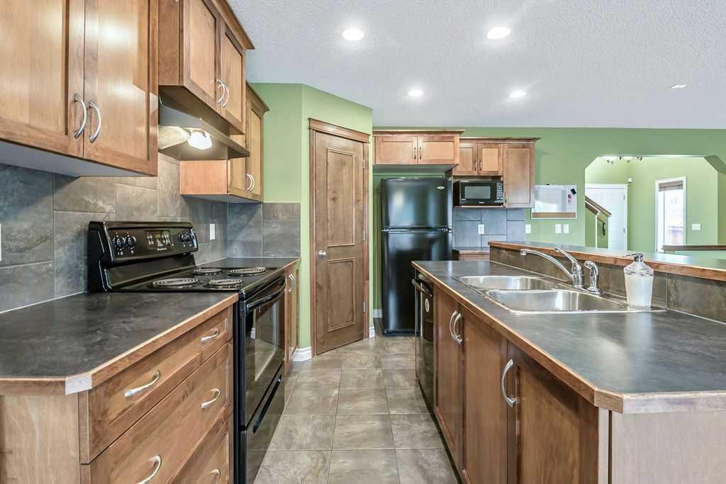 158 New Brighton Lane Se, Calgary, AB - Indoor Photo Showing Kitchen With Double Sink