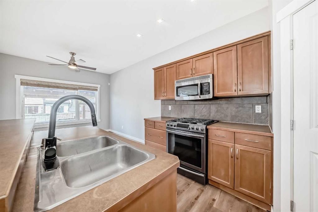 32 Copperleaf Way Se, Calgary, AB - Indoor Photo Showing Kitchen With Double Sink
